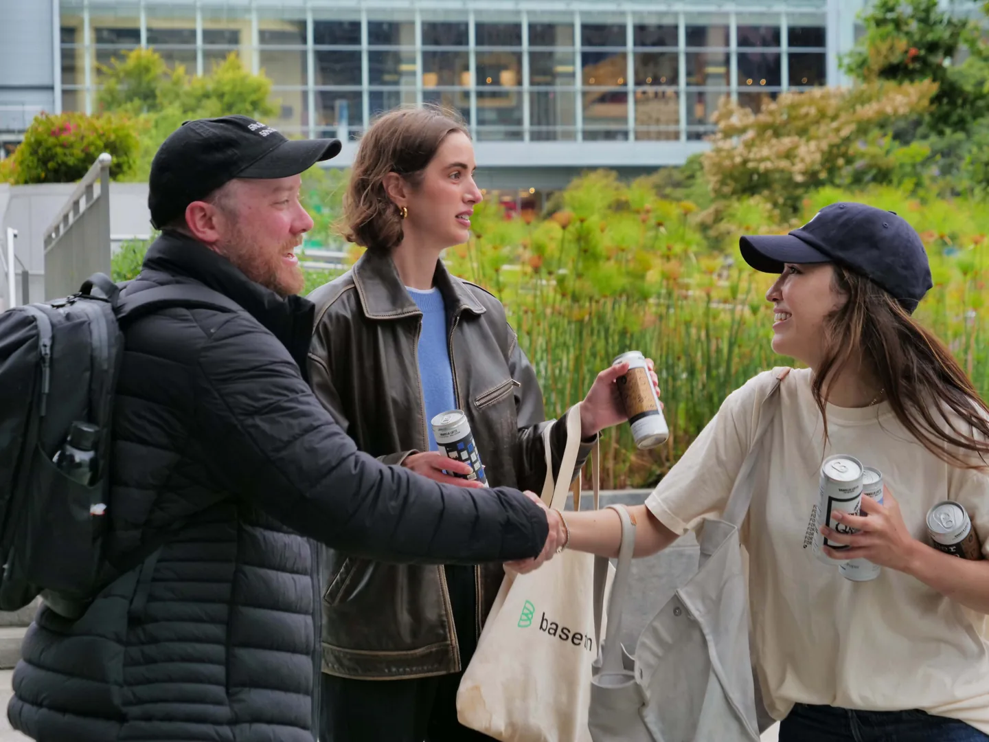 Three people interacting during the can handout