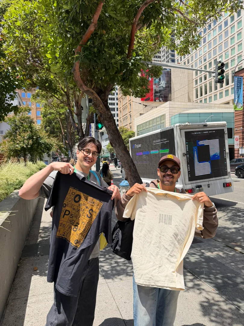 Two people holding up Paper shirts