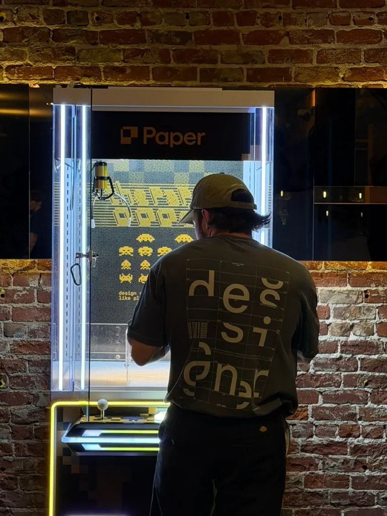 A person in a Paper shirt by a vending machine
