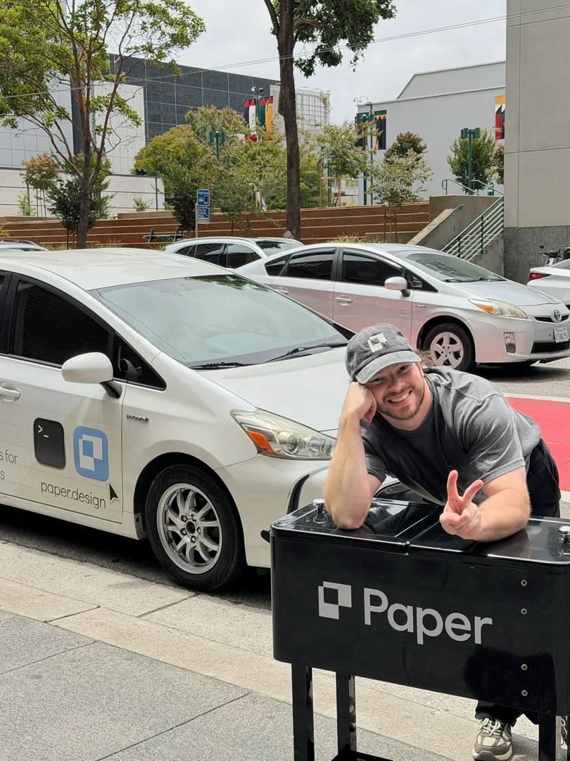 A Paper-wrapped taxi with a team member flashing a peace sign