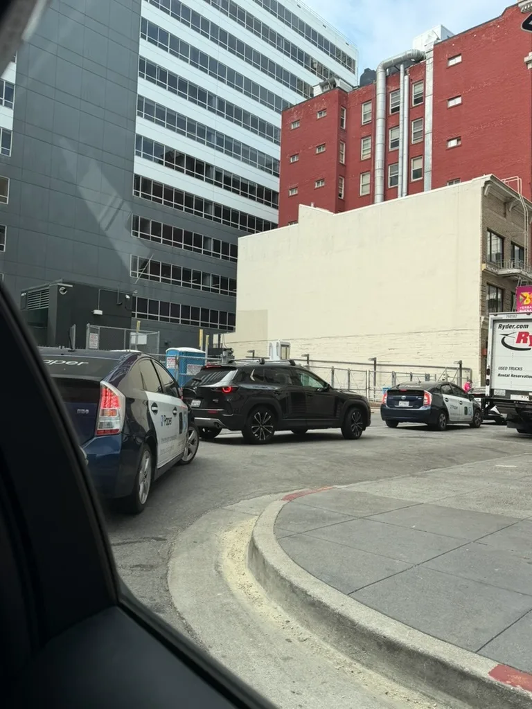 Paper taxis in SF traffic seen from a car window